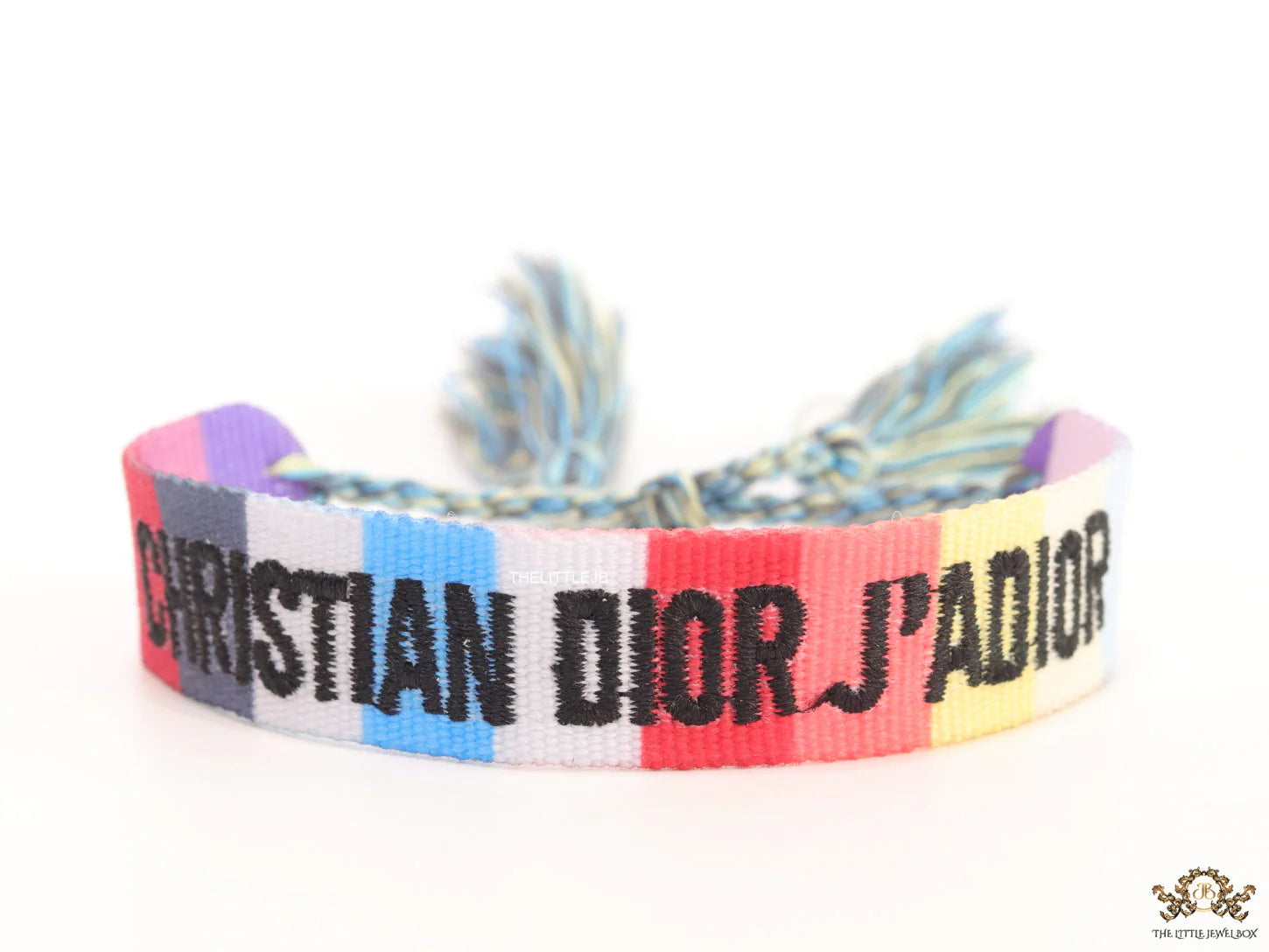 Adjustable multi color woven bracelet with black knitted alphabets and tassels