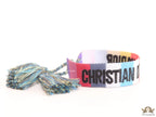 Adjustable multi color woven bracelet with black knitted alphabets and tassels