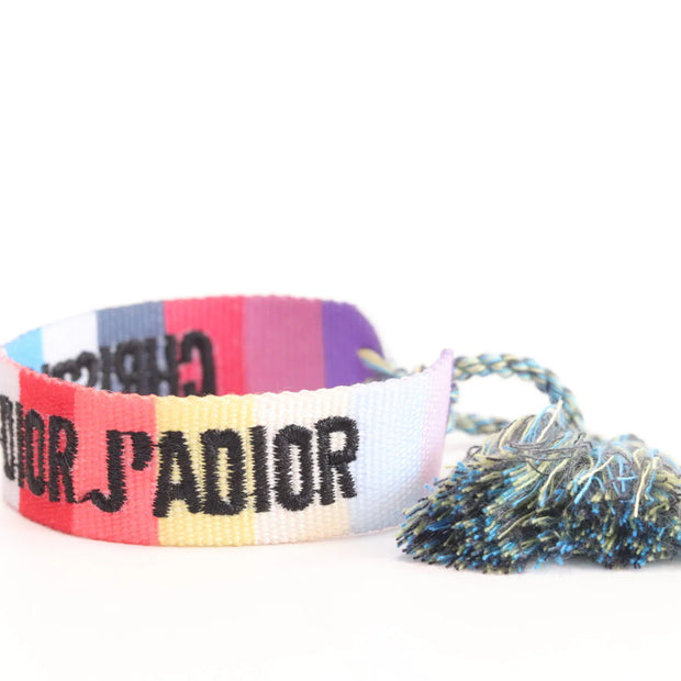 Adjustable multi color woven bracelet with black knitted alphabets and tassels