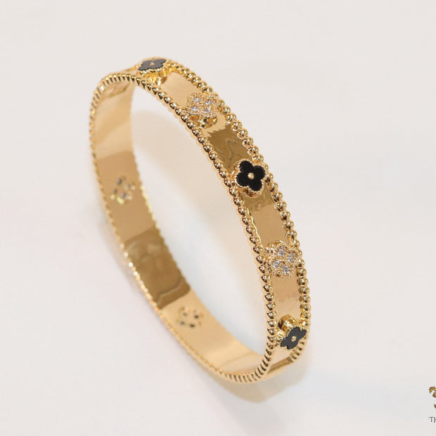 Gold plated bracelet with clover motifs in cz and black enamel