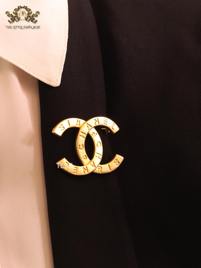 Double C embossed gold brooch