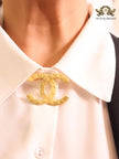 Double C embossed gold brooch