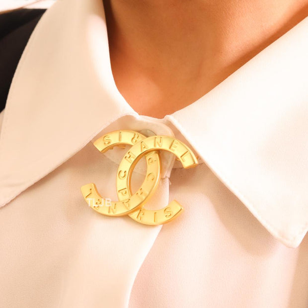 Double C embossed gold brooch