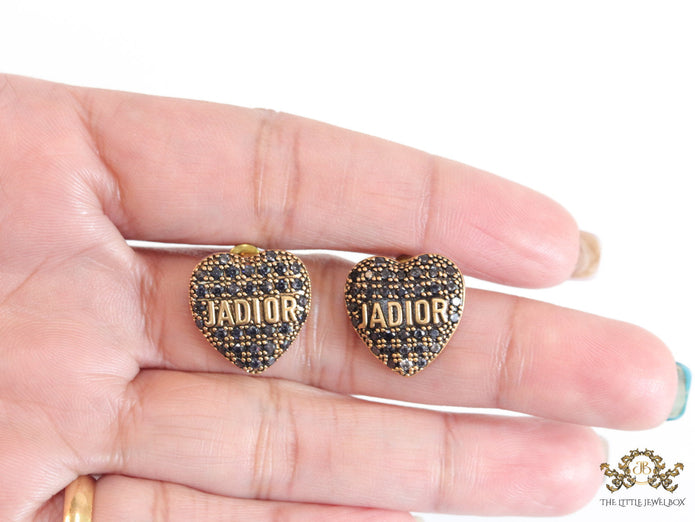 Heart shaped alphabet stud earrings in golden and black finish