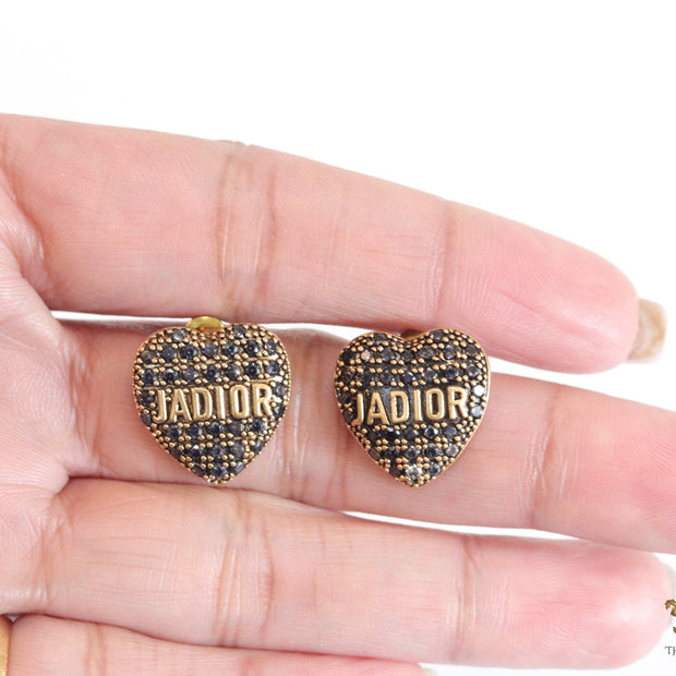 Heart shaped alphabet stud earrings in golden and black finish