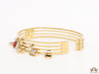 Multilayered golden bracelet with alphabets and coloured clover charms