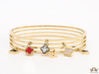 Multilayered golden bracelet with alphabets and coloured clover charms