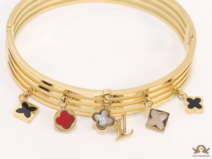 Multilayered golden bracelet with alphabets and coloured clover charms