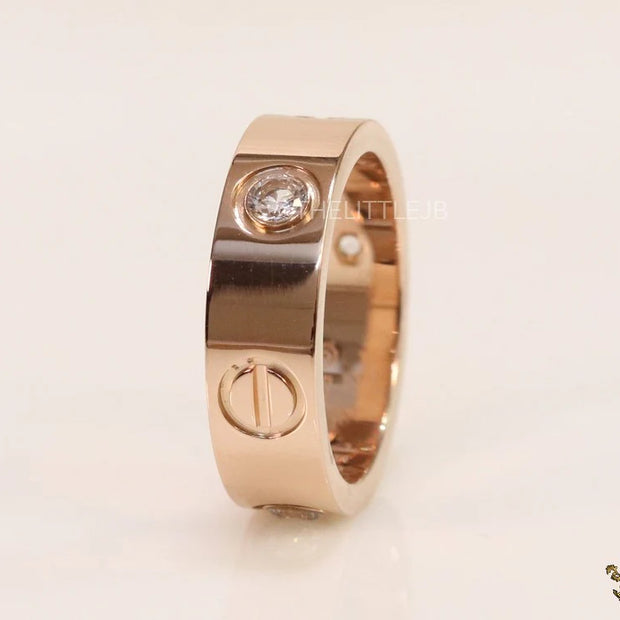 Broad 6mm rose gold band with screws and stones