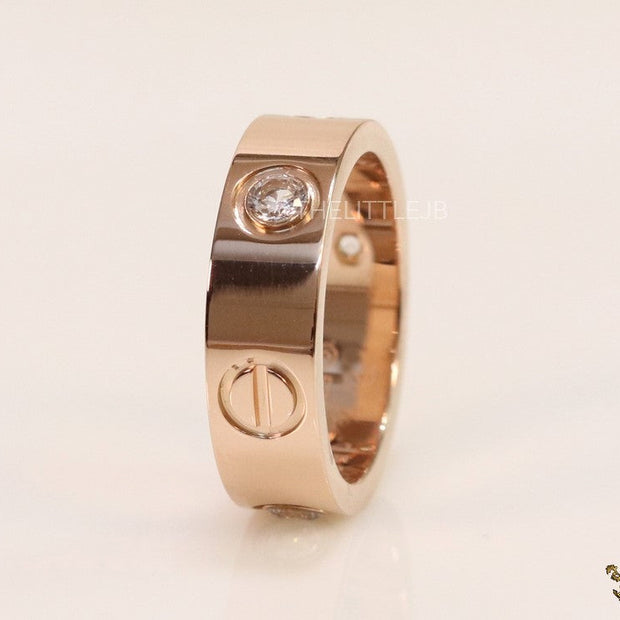 Broad 6mm rose gold band with screws and stones