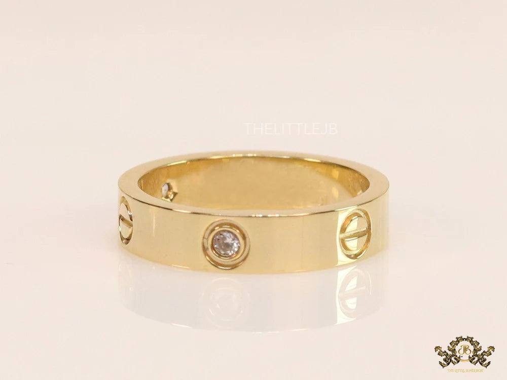 Broad 6mm gold plated band with screws and stones