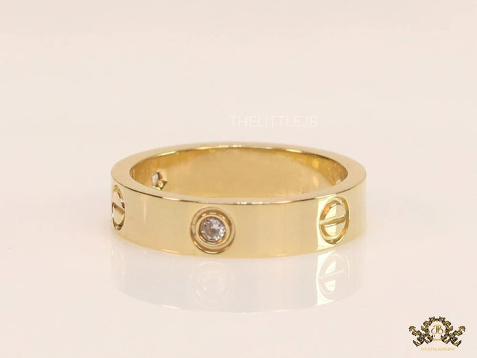 Broad 6mm gold plated band with screws and stones