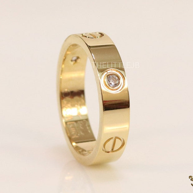 Narrow 4.5mm gold band with screws and stones