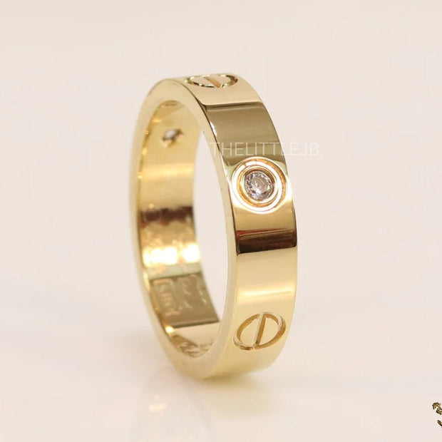 Broad 6mm gold plated band with screws and stones