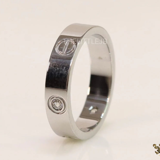 Narrow 4.5mm platinum plated band with screws and stones