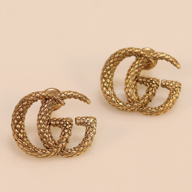 Gold plated earrings with double G initials