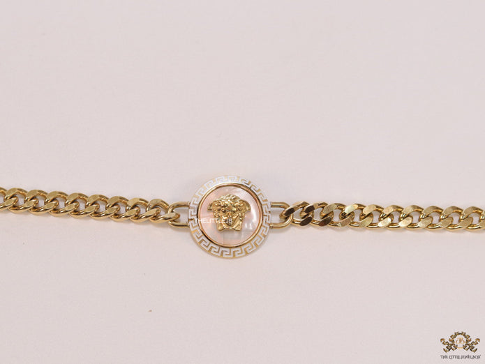 Golden link chain bracelet with Medusa motif centre