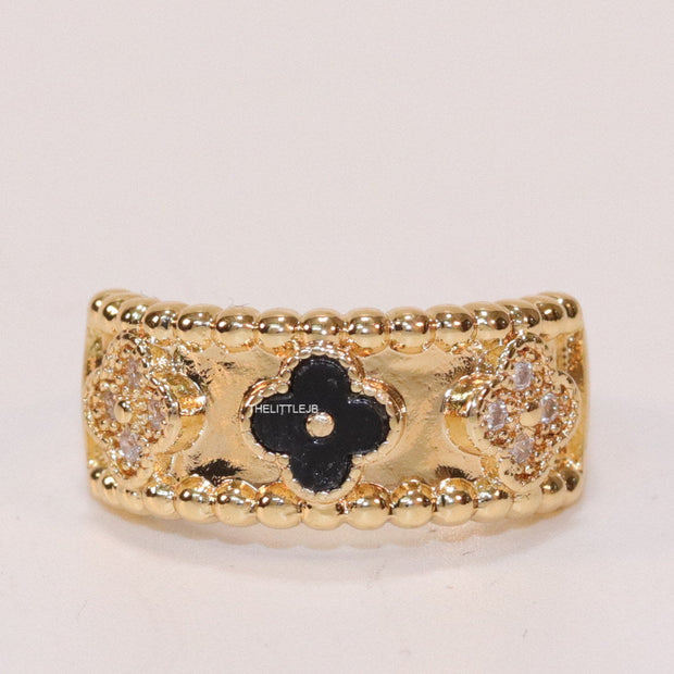 Golden ring band with black enamel and cz clovers