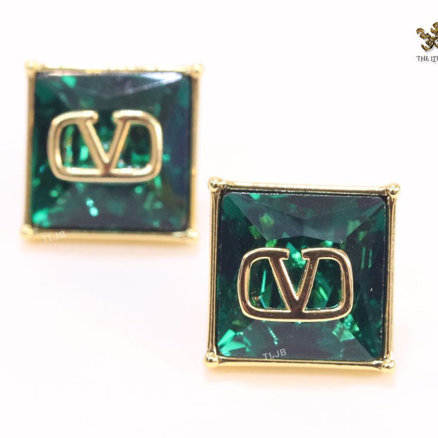Alphabet V blue and gold studs