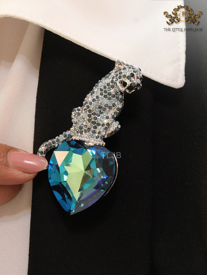 Inverted panther on heart-shaped London blue topaz brooch