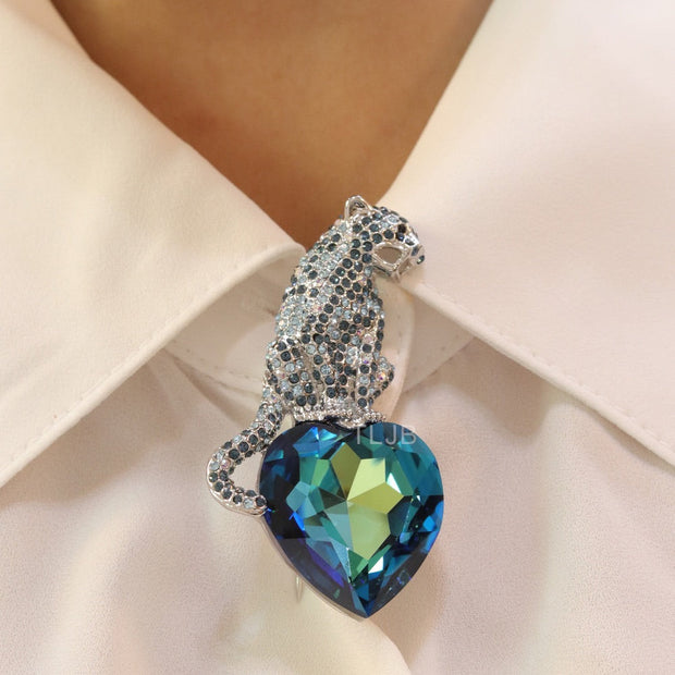 Inverted panther on heart-shaped London blue topaz brooch