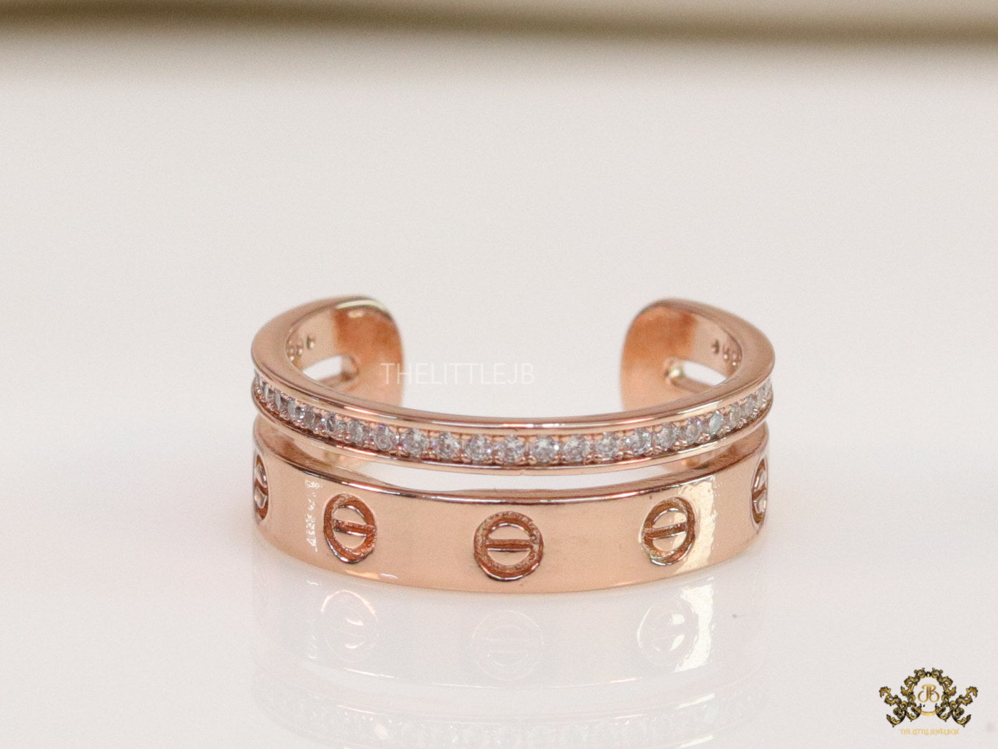 Double layered rose gold finish open ring with screws and cz