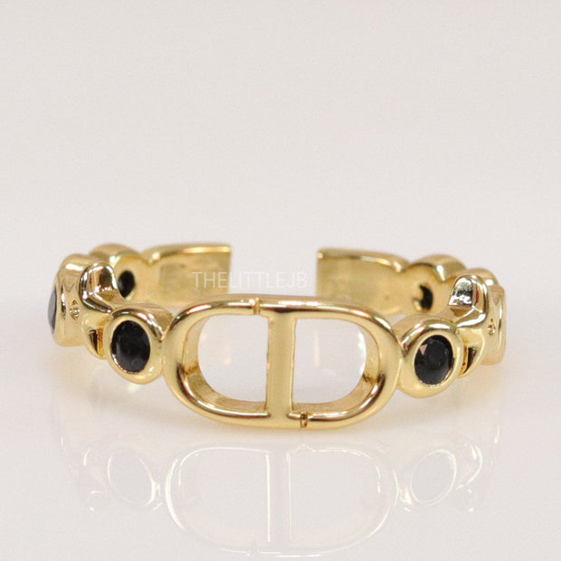 Gold finish alphabet open ring with black cz