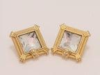 Square solitaires in gold boundaries with medusa