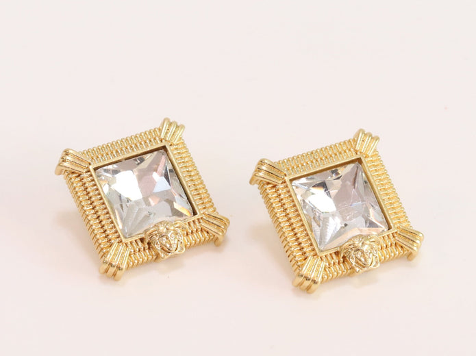 Square solitaires in gold boundaries with medusa