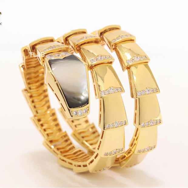 Bold gold and cz serpenti bracelet with black mop head