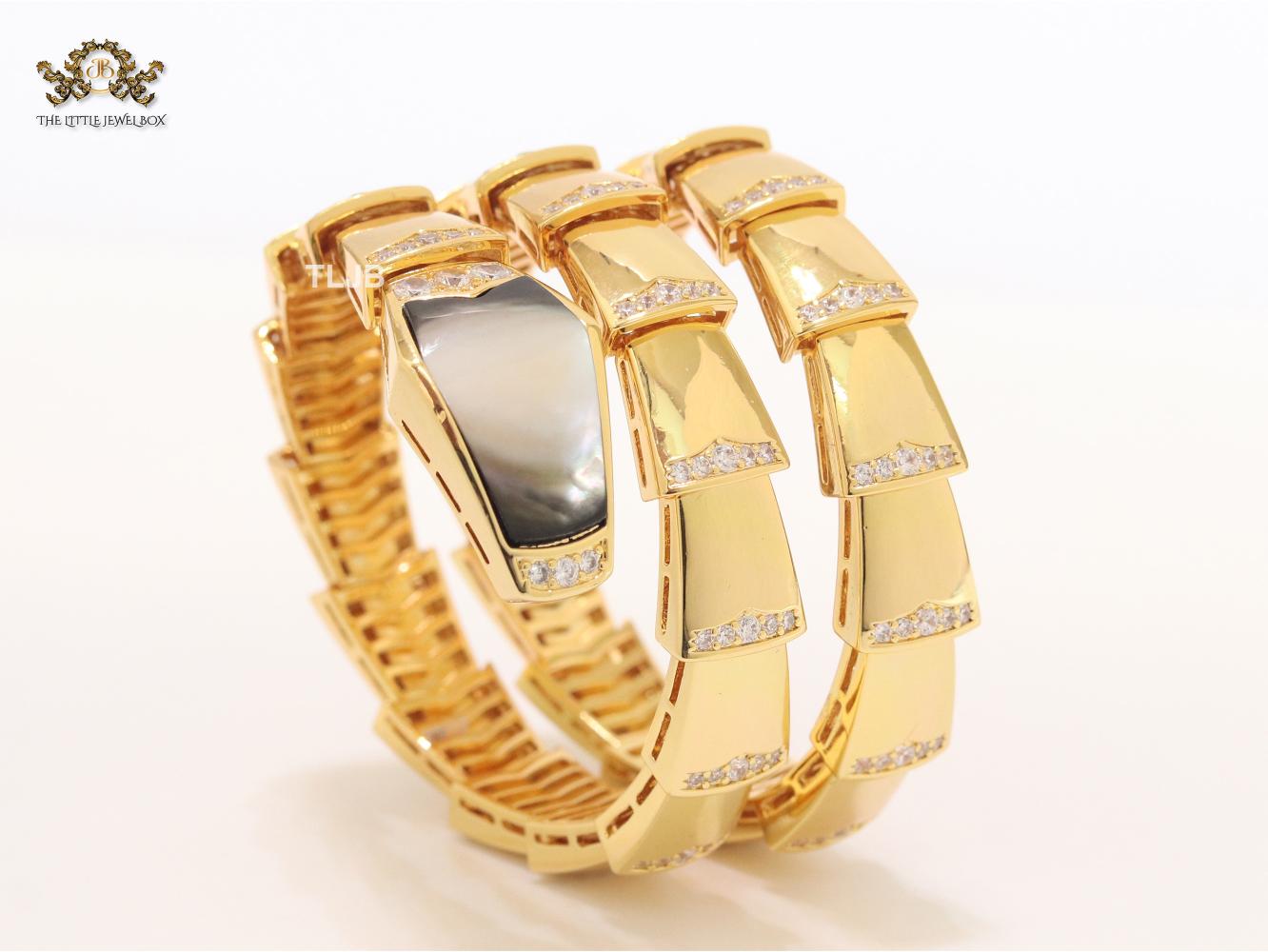 Bold gold and cz snake bracelet with black mop head