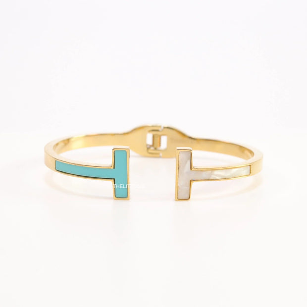 Gold plated open bracelet with blue enamel and MOP ends