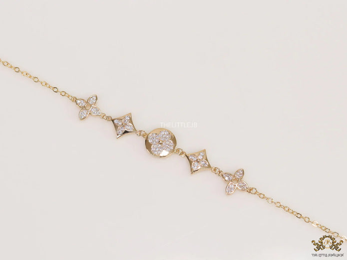 Gold plated chain bracelet with cz clovers and flowers