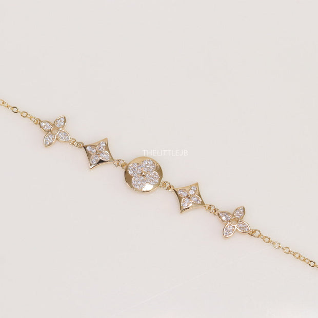 Gold plated chain bracelet with cz clovers and flowers