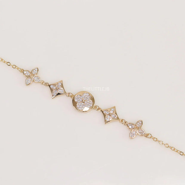 Gold plated chain bracelet with cz clovers and flowers