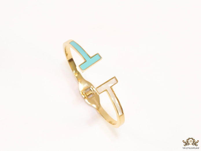 Gold plated open bracelet with blue enamel and MOP ends