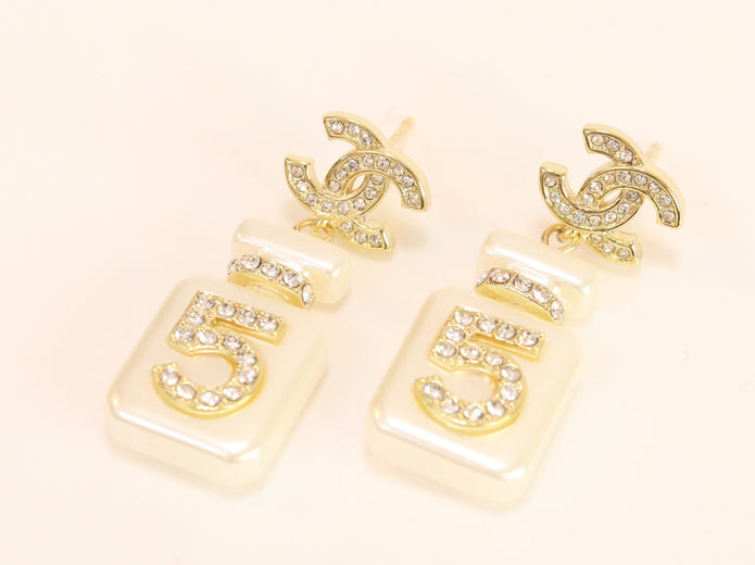 Double C gold danglers with 5 in CZ on white enamel