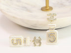 Double C gold danglers with 5 in CZ on white enamel