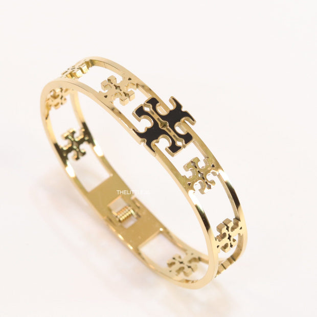 Gold plated openable bracelet with fancy cutwork T motifs