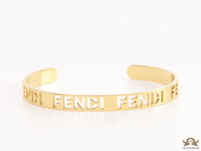 Gold plated open band bracelet with cutwork alphabets