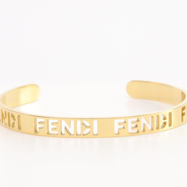 Gold plated open band bracelet with cutwork alphabets
