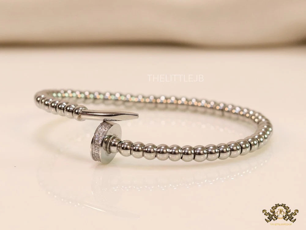 Platinum plated cz and metallic bead nail bracelet-openable