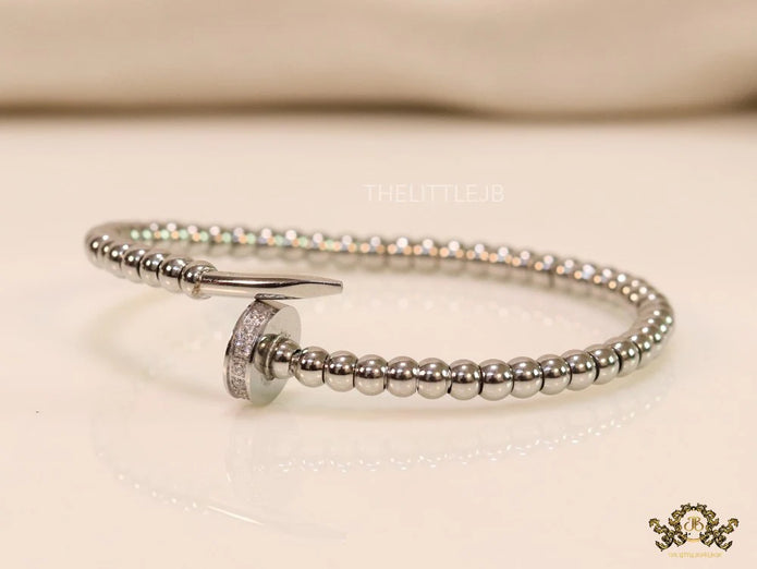 Platinum plated cz and metallic bead nail bracelet-openable