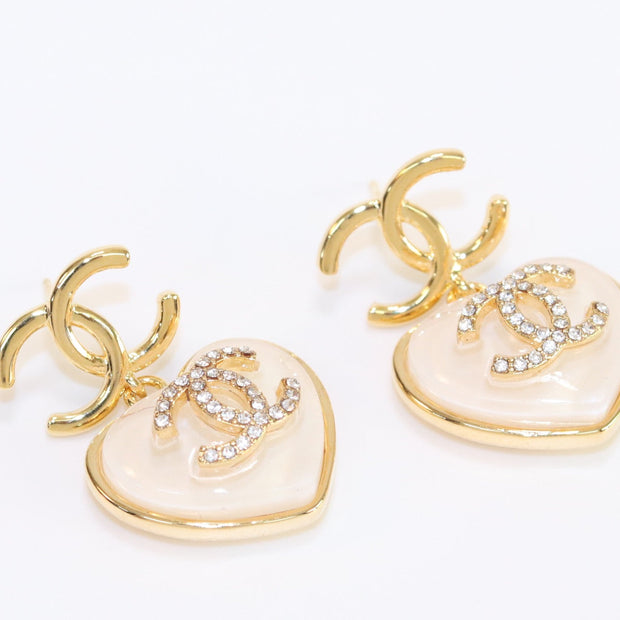 Double C on dangling cream heart gold earrings with CZ