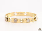 Gold plated cutwork twin T motif bracelet with white stones
