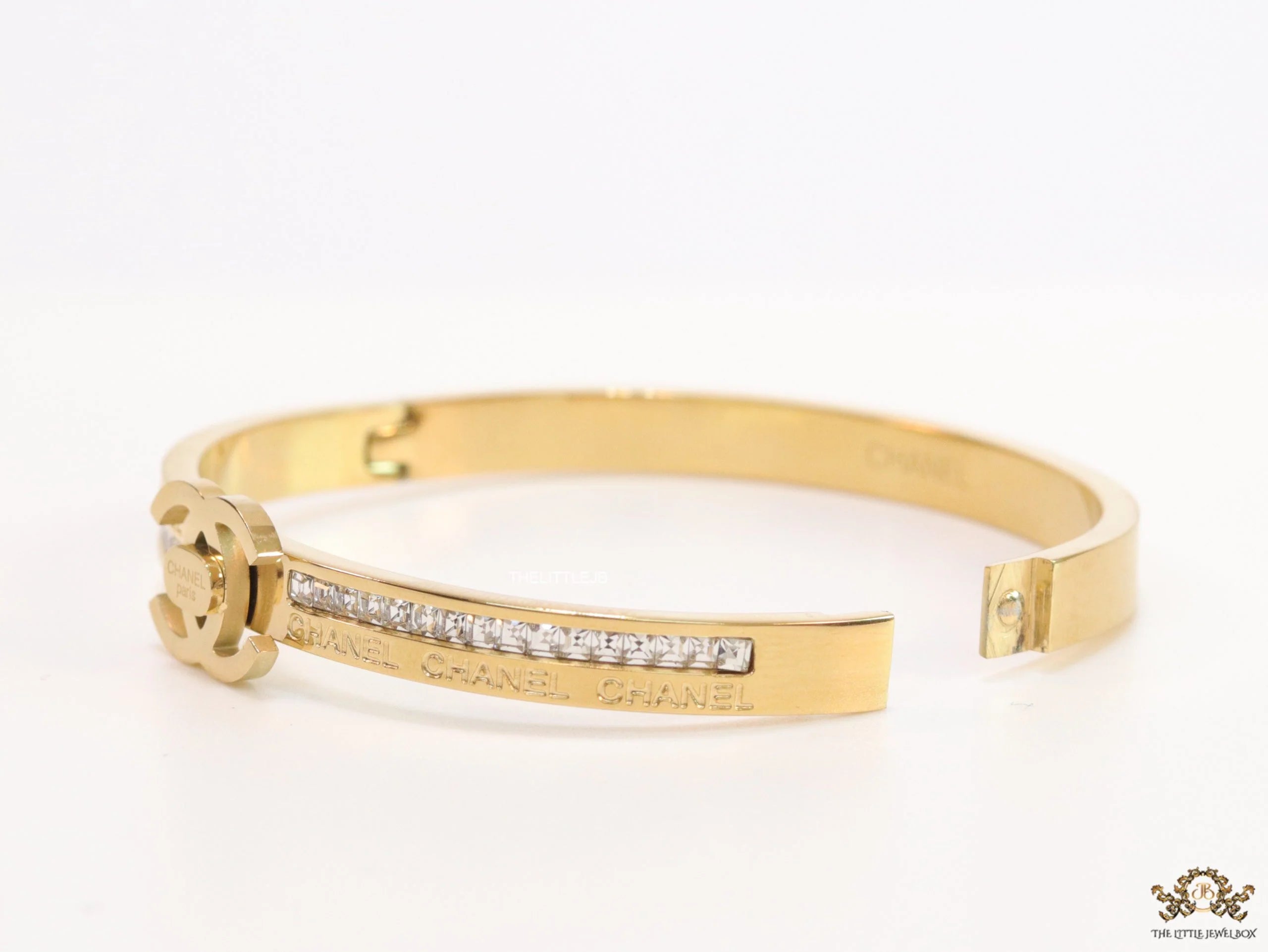Gold plated bracelet with cz, inscribed alphabets and twin disc motif