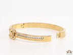 Gold plated bracelet with cz, inscribed alphabets and twin disc motif