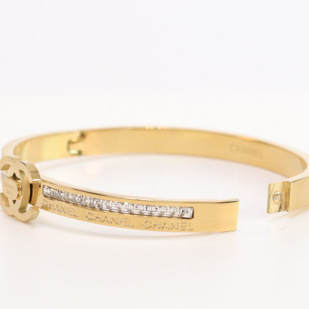 Gold plated bracelet with cz, inscribed alphabets and twin disc motif