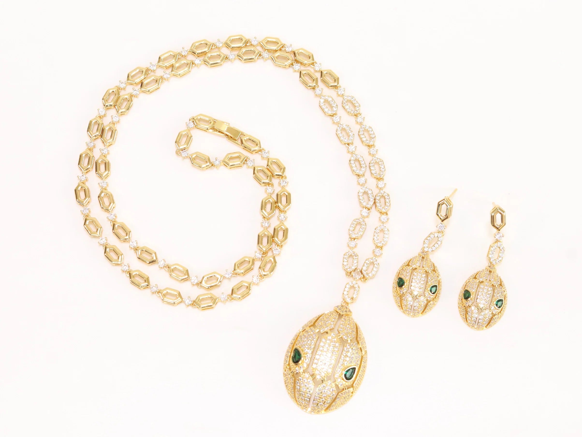 Gold Snake head pendant set with emerald detailing