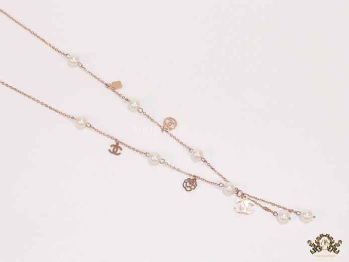 Gold chain necklace with pearls and alphabet motifs